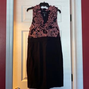 INC sleeveless black and pink dress with ruffled vee neckline.